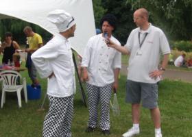 Presenter Chris Daniels gets some cooking tips from the Zooted Mad Chefs